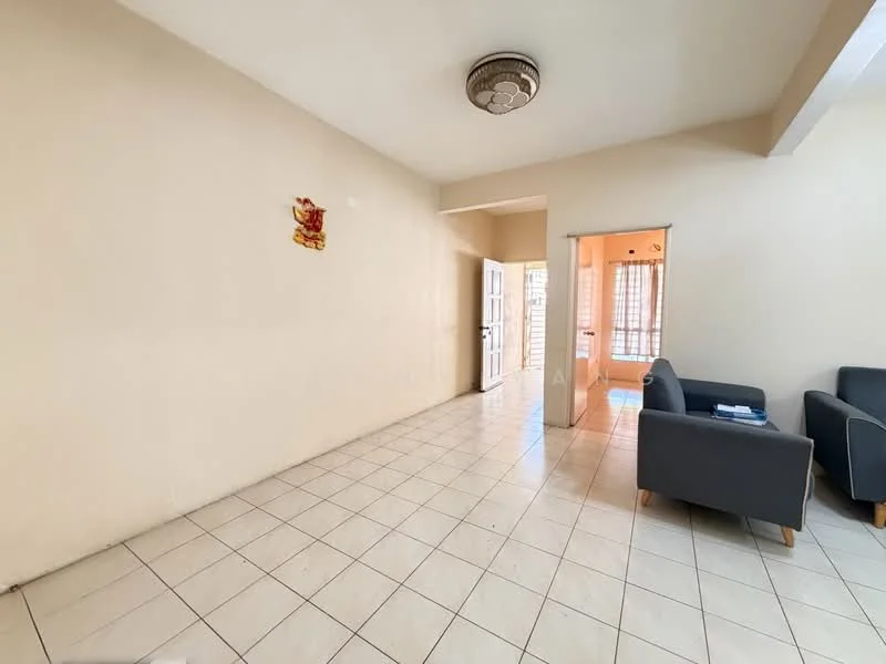 Living features: cream painted walls, white tiled flooring, ceiling fan with light, two grey fabric sofas, decorative wall art, large window with natural light, open layout to adjacent room. Room features: white tiled flooring, cream painted walls, doorway leading to another room, natural light from window.