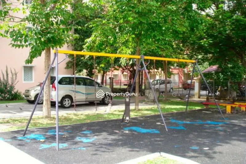 Exterior type: landscape garden; features: swing set, manicured lawn, paved pathway, surrounding trees, parking area, playground equipment; style: modern.