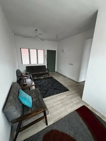 Living features: light grey fabric sofa, dark grey fabric sofa, area rug with geometric pattern, wooden coffee table, ceiling fan, white painted walls, laminate flooring, large windows with metal grilles, green door; style: modern.