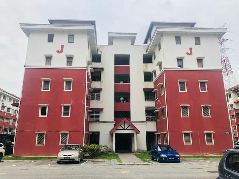 Exterior type: low-rise apartment block; features: red and white painted facade, three-storey building, balconies with metal railings, multiple windows on each floor, central entrance with awning, parking spaces in front, surrounded by greenery; style: modern.