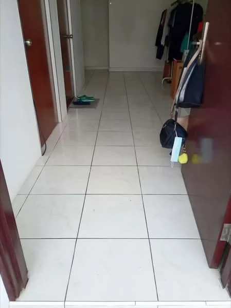 Room features: white ceramic tile flooring, plain white walls, two wooden doors, one open doorway, hanging clothes rack, slippers on the floor; style: modern.