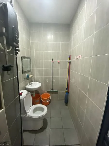 Bathroom features: grey tiled walls, grey tiled flooring, one-piece toilet, framed mirror, shower with water heater, cleaning supplies, two orange buckets, broom, mop.