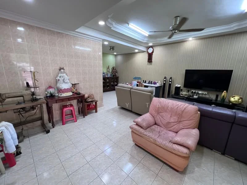 Living features: cream tiled flooring, light brown painted walls, crown moulding, 5-blade ceiling fan, wall-mounted TV, brown leather sofa, pink armchair, wooden coffee table, decorative wall clock, decorative items on shelves, exposed brick feature wall, artwork on wall; style: traditional.