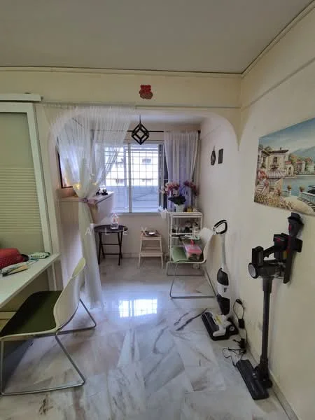 Room features: white painted walls, marble flooring, large window with sheer curtains, decorative wall art, small table with chairs, floor lamp, vacuum cleaner, cleaning equipment, potted plants, shelf with decorative items, light fixture, arched doorway; style: modern.