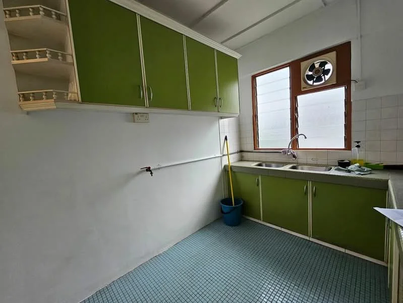 Kitchen features: green cabinetry, white countertop, single-bowl stainless-steel sink, chrome pull-down faucet, window with ventilation fan, tile backsplash, blue mosaic tile flooring, open shelving, cleaning supplies in blue bucket.