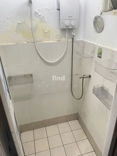 Bathroom features: white tiled walls, white tiled flooring, shower area, wall-mounted shower head, shower mixer, built-in soap shelves, mirror, water heater, grout lines visible, peeling paint on walls.