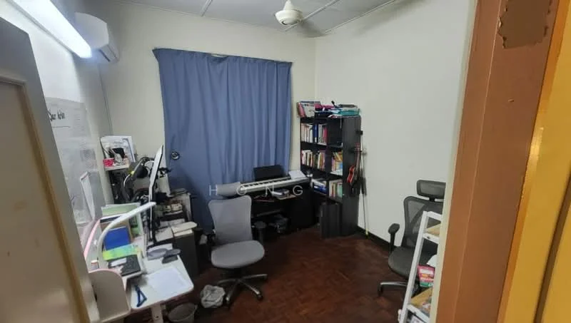 Study features: wooden flooring, blue curtain, wall-mounted air conditioning unit, desk with computer setup, office chair, bookshelf with books, two additional chairs, light fixture on ceiling.