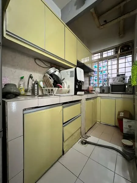 Kitchen features: yellow cabinetry, white tiled backsplash, stainless-steel sink, chrome faucet, built-in microwave, freestanding range oven, countertop with space for appliances, dish rack, window with stained glass, tile flooring.