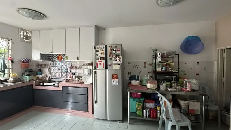 Kitchen features: white cabinetry with flat-panel doors, grey countertop, stainless-steel fridge, built-in gas stove, decorative tile backsplash with colorful patterns, double-basin sink, metal shelving unit, microwave, kettle, plastic storage containers, dining table with plastic chairs, floor tiles in light green, ceiling lights, window with metal grille; style: modern.