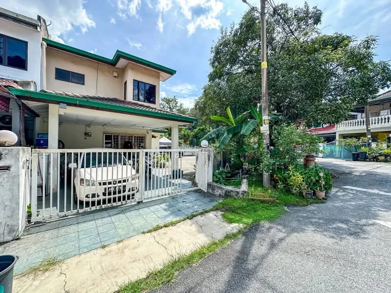 Exterior type: semi-detached house; features: white painted facade, green roof, car porch with awning, manicured lawn, mature trees, paved driveway, fenced front yard, garden with plants, street view, adjacent to residential area; style: modern.