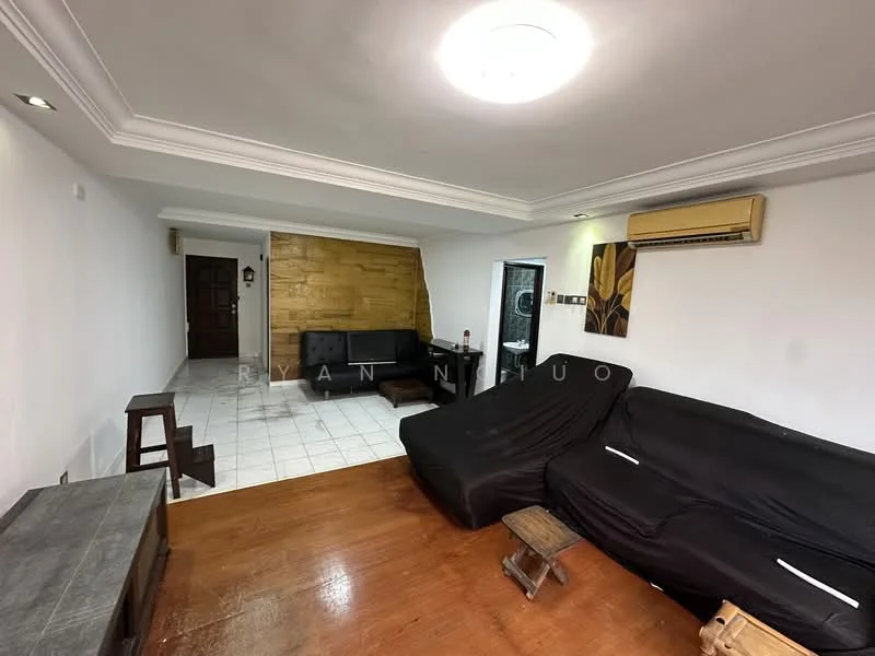 Living features: black fabric L-shape sectional sofa, wooden coffee table, white painted walls, wood panel accent wall, tile flooring, recessed ceiling lights, wall-mounted air conditioning unit, door leading to outside, decorative wall art, wooden side table; style: modern.