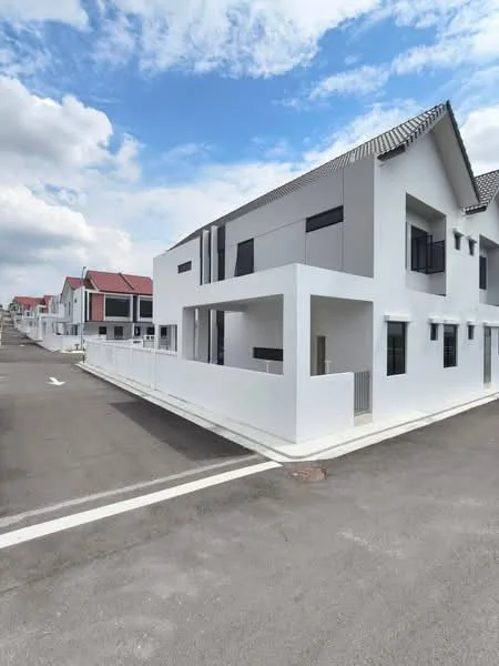 Exterior type: linked terrace house; features: white painted facade, grey accent panels, flat roof, two-storey structure, manicured walkway, surrounded by other houses, driveway, clear blue sky, paved road; style: modern.