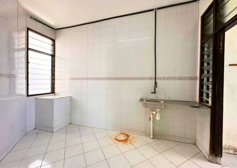 Laundry features: white tiled walls, white tiled flooring, single-bowl stainless-steel sink, window with horizontal slats, corner countertop, plumbing visible, drainage pipe, no visible appliances.