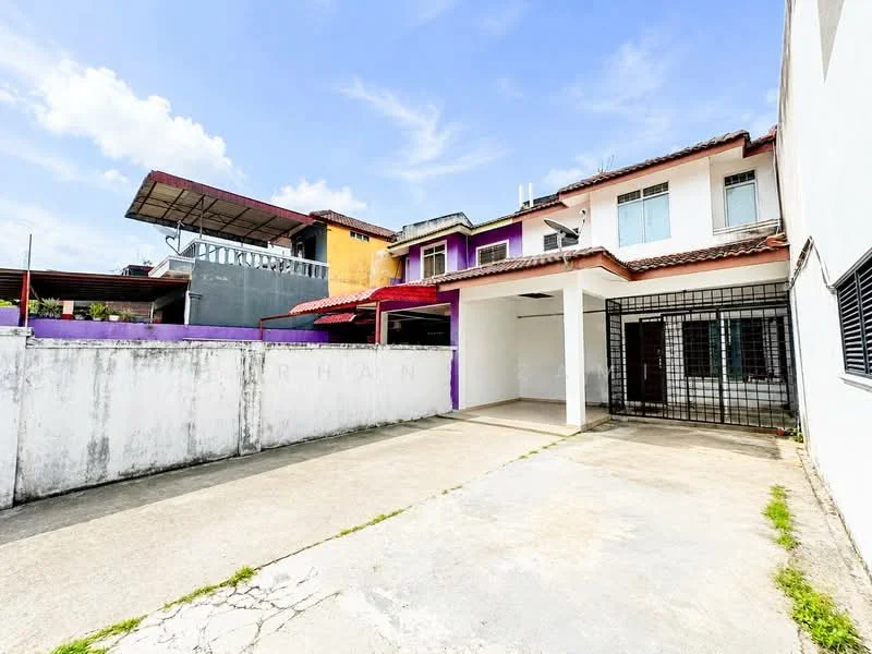 Exterior type: semi-detached house; features: two-storey structure, purple and white painted facade, flat roof, concrete driveway, fenced perimeter, outdoor parking space, balcony on upper floor, visible air conditioning units, manicured lawn area, surrounding wall, clear blue sky; style: modern.