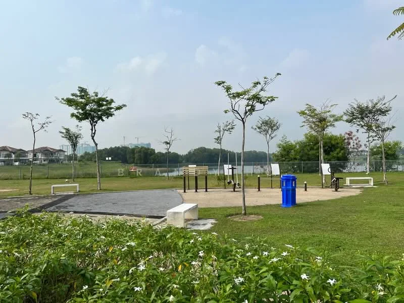 Exterior type: landscape garden; features: manicured lawn, mature trees, walking path, park benches, outdoor exercise equipment, blue recycling bin, surrounding greenery, fenced area, open sky; style: modern.