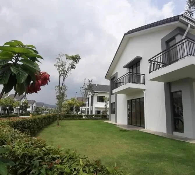 Exterior type: detached bungalow; features: white painted facade, black window frames, recessed balconies, manicured lawn, landscaped garden with shrubs, paved walkway, two-storey structure, gated entry, surrounded by greenery; style: modern.