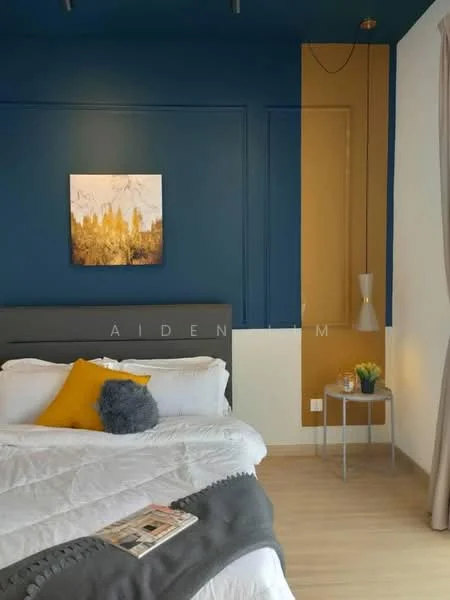 Bedroom features: king-size bed with white bedding, decorative yellow throw pillow, grey throw blanket, blue accent wall, gold accent wall, wooden flooring, nightstand with lamp, small potted plant on nightstand, framed artwork on wall, recessed lighting; style: modern.