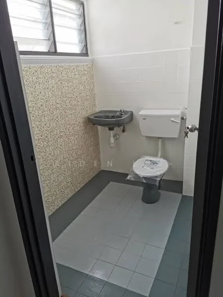 Bathroom features: toilet, sink, grey tiled flooring, white tiled walls, textured wall panel, window with louvered design, wall-mounted faucet, flush toilet, plastic toilet seat cover.