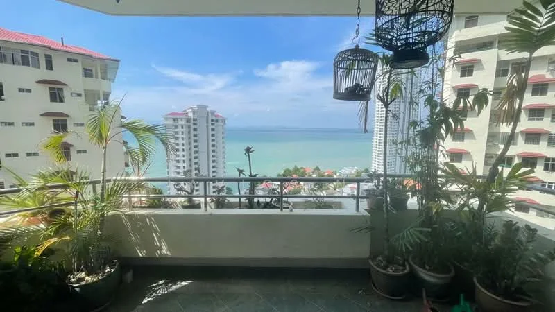 Room features: balcony with railing, sea view, potted plants, tile flooring, overhead hanging planter, city skyline in background, sunlight exposure, outdoor space; view: sea.