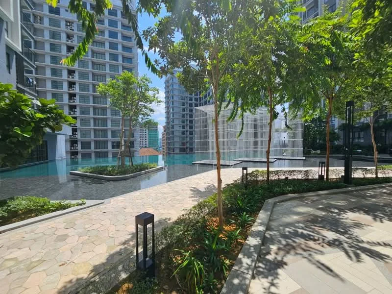 Exterior type: high-rise condominium; features: landscape garden, manicured lawn, mature trees, stone-paved walkway, infinity pool, water feature, outdoor lighting, surrounded by greenery; style: modern.