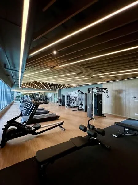 Gym features: wooden flooring, exposed wooden beams on ceiling, recessed LED downlights, large floor-to-ceiling windows, various gym equipment including treadmills and weight machines, multi-functional weight training machine, exercise mats, mirrored wall; style: modern; view: city.