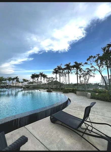 Exterior type: swimming pool deck; features: infinity pool, pool deck with loungers, tropical landscaping, palm trees, manicured lawn, concrete paving; style: modern.