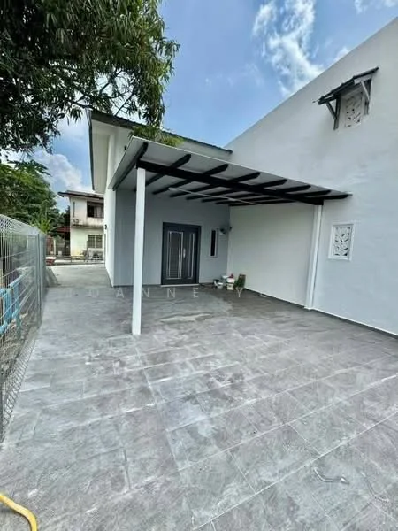 Exterior type: detached bungalow; features: flat roof with overhang, grey tiled flooring, white painted facade, double-door main entrance, decorative wall panels, surrounding fence, landscaped area with potted plants, clear blue sky, mature trees nearby; style: modern.