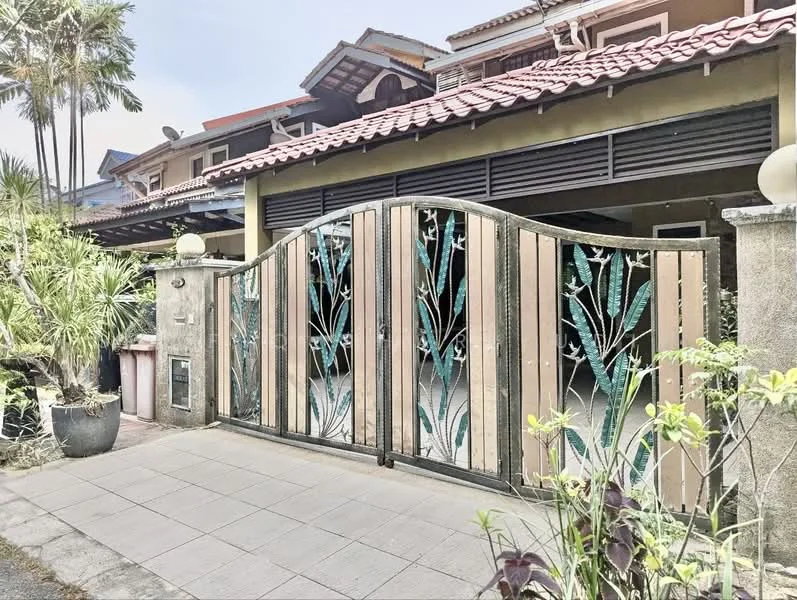 Exterior type: linked terrace house; features: decorative metal gate with floral design, paved driveway, manicured landscaping, tropical plants, red tiled roof, two-storey structure, front porch area, wall-mounted outdoor lighting; style: modern.