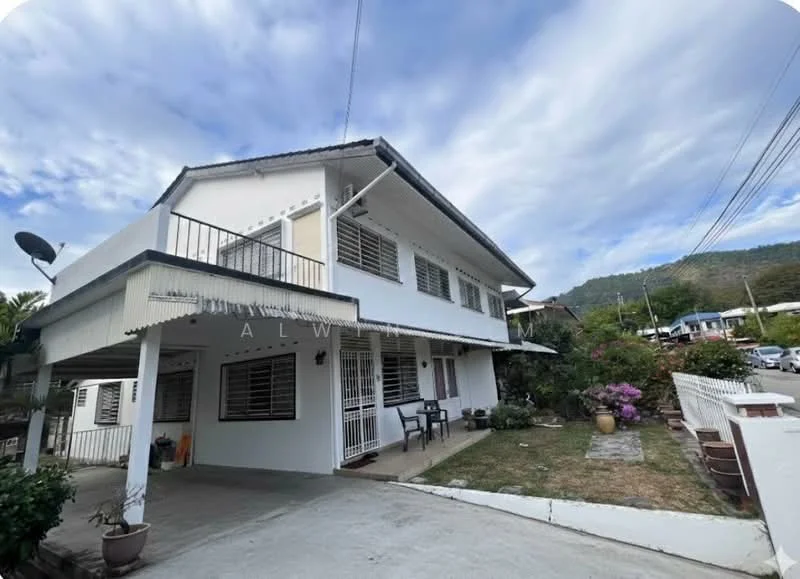Exterior type: semi-detached house; features: white painted facade, flat roof, two-storey structure, balcony with railing, manicured lawn, paved walkway, garden area with potted plants, satellite dish, surrounded by greenery, driveway, mountain view in background; style: modern.