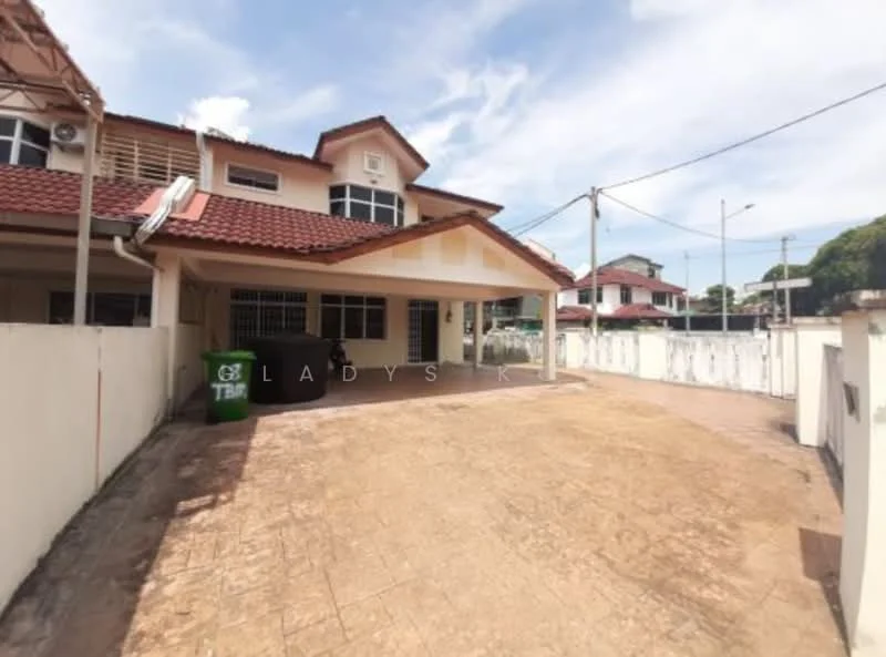 Exterior type: semi-detached house; features: red tiled roof, cream painted facade, front porch area, manicured lawn, concrete driveway, visible garbage bin, surrounded by white fencing, two-storey structure, windows with grilles, outdoor lighting, paved walkway; style: modern.