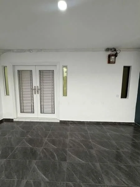 Room features: white painted walls, grey tiled flooring, double French doors with horizontal slats, two narrow vertical windows, ceiling light fixture; style: modern.