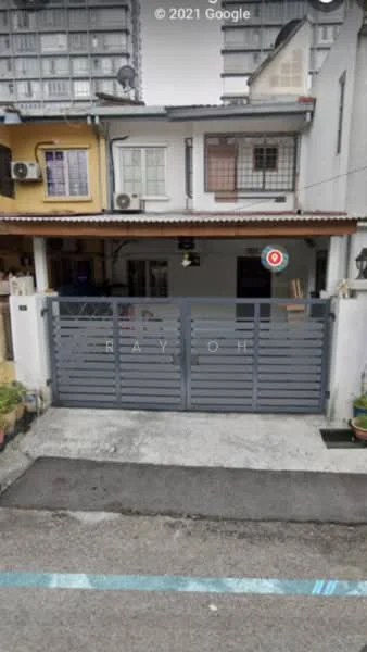 Exterior type: linked terrace house; features: grey metal gate, concrete driveway, two-storey building, balcony on upper floor, air conditioning units visible, painted facade in yellow and white, roof overhang, potted plants at entrance; style: modern.