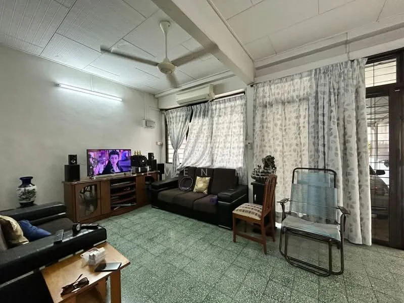 Living features: black fabric sofa, 3-seater sofa, wooden coffee table, TV console, wall-mounted TV, ceiling fan, light grey walls, green tiled flooring, sheer curtains, decorative vase, wooden chair, metal folding chair.