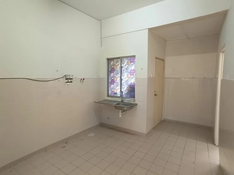 Room features: white painted walls, grey tiled flooring, single-bowl stainless-steel sink, window with stained glass, doorway leading to another room, wall-mounted plumbing fixtures, no visible cabinetry, minimal decor; style: minimalist.
