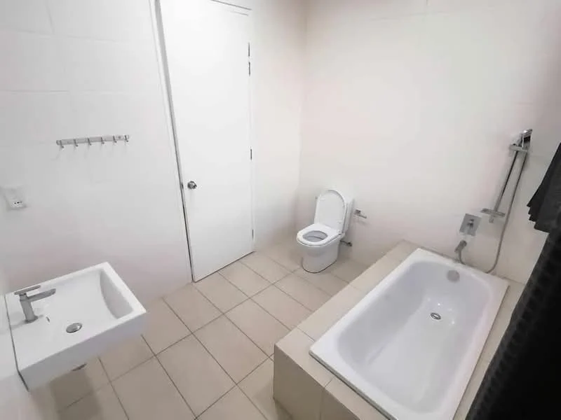 Bathroom features: white tiled walls, light beige floor tiles, single-sink vanity with modern faucet, built-in bathtub, one-piece toilet, shower with handheld showerhead, towel rack, door, mirror above sink; style: modern.