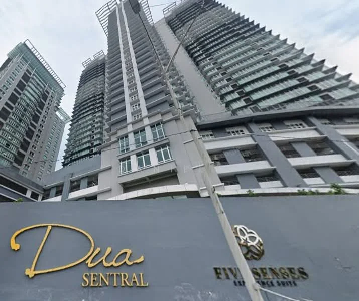 Exterior type: high-rise condominium; features: glass curtain wall, grey painted facade, recessed balconies, multiple storeys, signage for 'Dua Sentral', signage for 'Five Senses', modern architectural design, surrounded by urban landscape; style: modern.