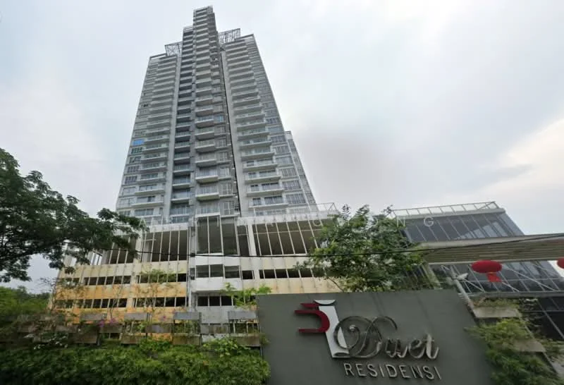 Exterior type: high-rise condominium; features: glass curtain wall, projecting balconies, approximately 20-storey high-rise, manicured landscaping, signage at entrance, multi-storey car park, surrounded by mature greenery; style: modern.