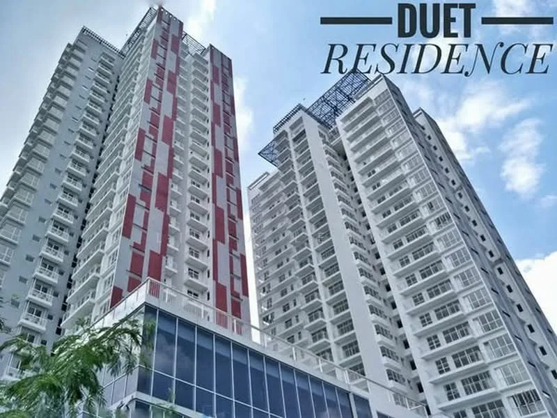 Exterior type: high-rise condominium; features: glass curtain wall, red and white painted facade, recessed balconies, multiple storeys, outdoor terrace, modern architectural design; style: modern.