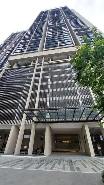 Exterior type: high-rise condominium; features: glass curtain wall, vertical fins, recessed balconies, covered entrance with awning, manicured landscaping, paved walkway, multiple storeys, modern facade; style: modern.