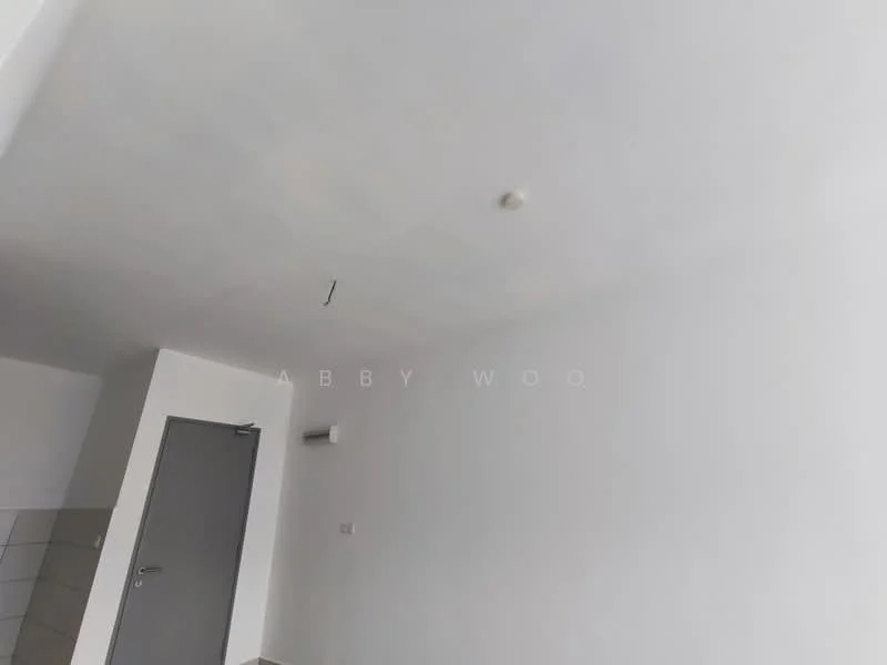 Room features: white painted walls, grey tiled flooring, ceiling light fixture, wall-mounted air conditioning unit, single door, corner wall with no visible features.