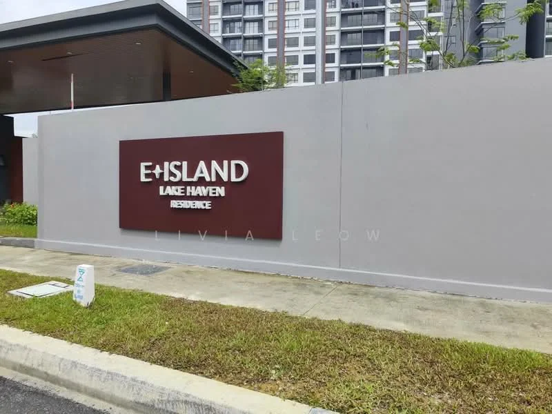 Exterior type: residential development; features: signage with 'E+ISLAND LAKE HAVEN RESIDENCE', concrete wall, landscaped area, paved pathway, surrounding greenery; style: modern.