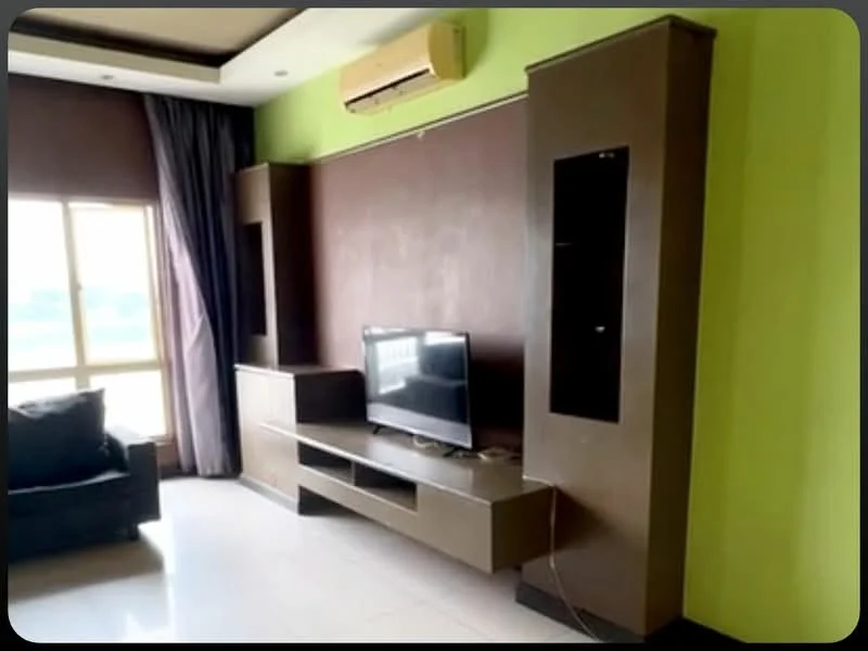 Living features: dark brown feature wall, green painted walls, white tiled flooring, wall-mounted TV, TV console with storage, built-in shelves, black fabric sofa, floor-to-ceiling window, curtains, wall-mounted air conditioning unit, recessed ceiling lights; style: modern; view: city.