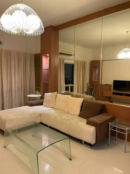 Living features: L-shape sectional sofa in beige and brown, glass coffee table, wall-mounted TV, wooden TV console, floor-to-ceiling mirror, sheer curtains, recessed downlights, 1 wall-mounted split AC, decorative pendant light; style: modern; view: city.