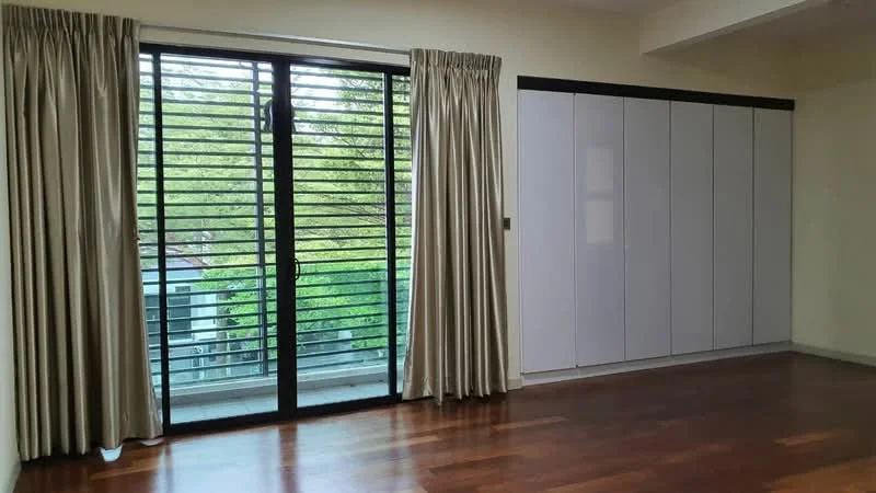 Room features: wooden flooring, cream painted walls, floor-to-ceiling sliding glass door, black metal window grilles, light-colored curtains, built-in wardrobe with white finish, natural light from windows, view of greenery outside; style: modern; view: garden.
