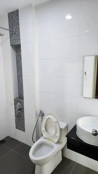 Bathroom features: white tiled walls, grey floor tiles, built-in shower with glass partition, chrome showerhead, toilet, bidet spray, single-sink vanity with black countertop, framed mirror; style: modern.