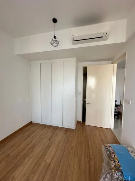 Bedroom features: wooden flooring, white painted walls, built-in wardrobe with sliding doors, ceiling light fixture with pendant design, wall-mounted split AC, door leading to hallway, natural light from door, minimalist decor; style: modern.
