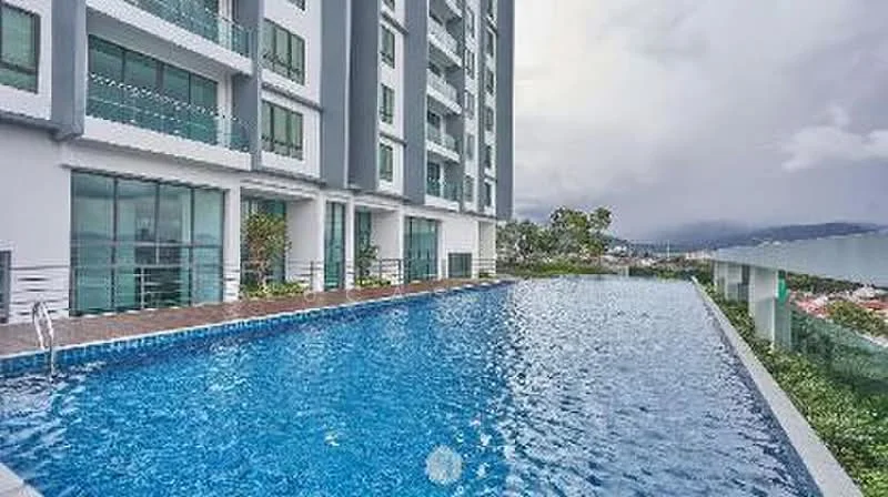 Exterior type: high-rise condominium; features: infinity pool, pool deck with loungers, glass railing, landscaped garden area, floor-to-ceiling windows, modern facade, surrounded by greenery, city skyline view; style: modern.