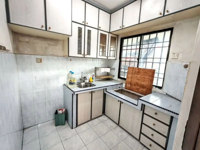 Kitchen features: white laminate cabinetry with wood accents, single-bowl stainless-steel sink, chrome faucet, countertop with tiled backsplash, built-in oven, gas hob, window with metal grille, ceramic tile flooring, wall-mounted storage shelves, under-sink storage cabinet, drawer storage, cleaning supplies visible.
