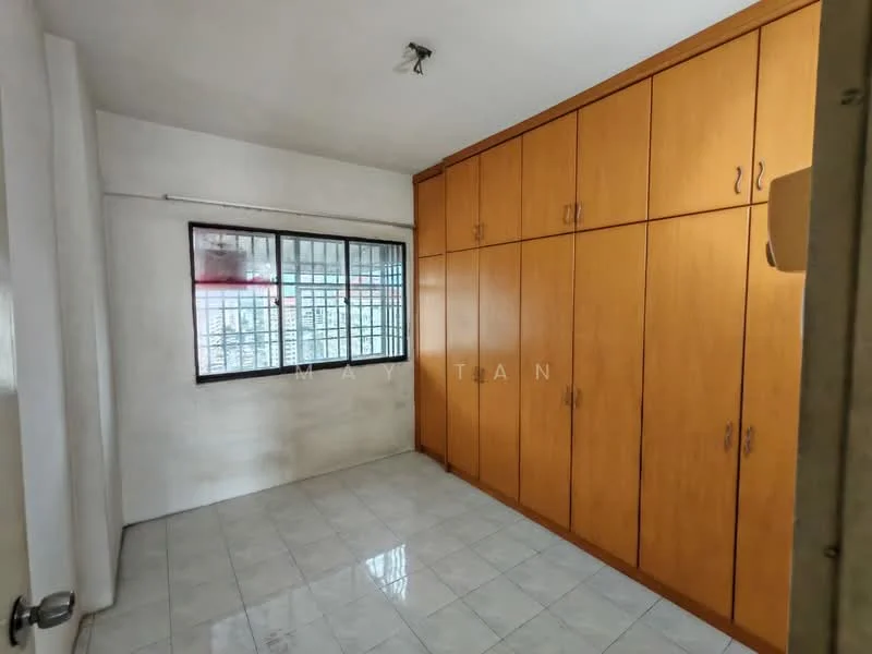 Bedroom features: white painted walls, glossy ceramic tile flooring, built-in wardrobe with wooden doors, window with metal grille, ceiling light fixture, neutral color scheme.