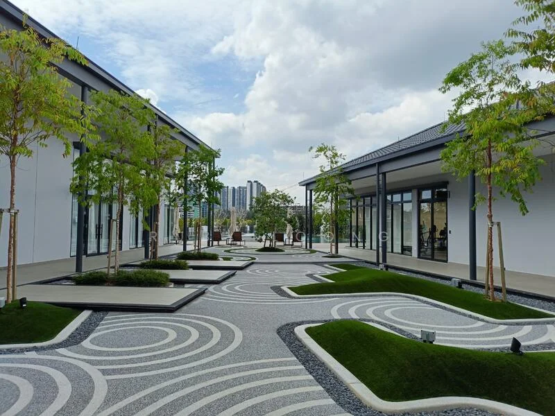Exterior type: landscape garden; features: manicured lawn, decorative stone pathways, modern landscaping with geometric patterns, trees with green foliage, outdoor seating area, surrounding buildings in background, paved walkways, open sky with clouds; style: modern.